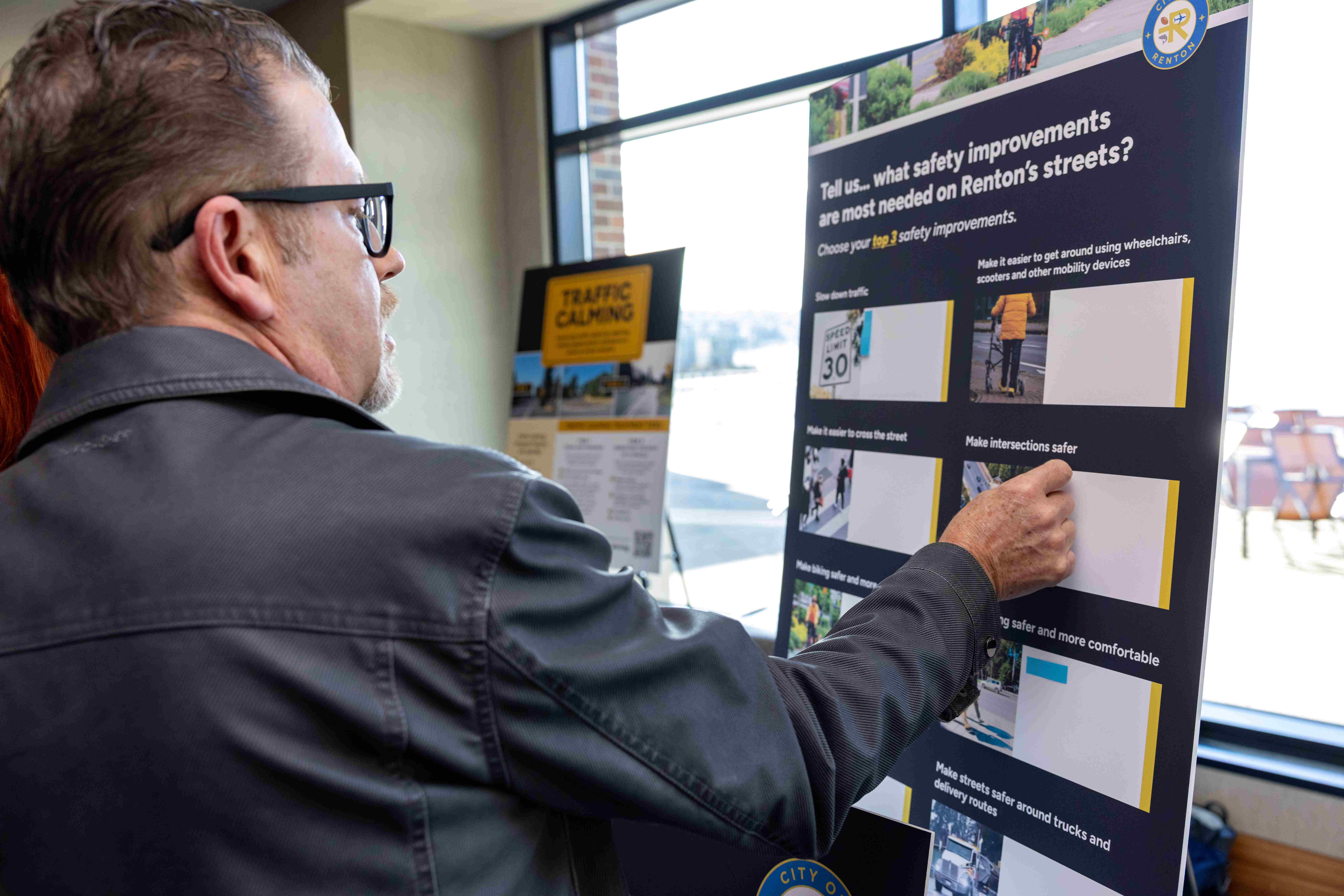 Resident engaging with staff project during State of the City 2026 reception
