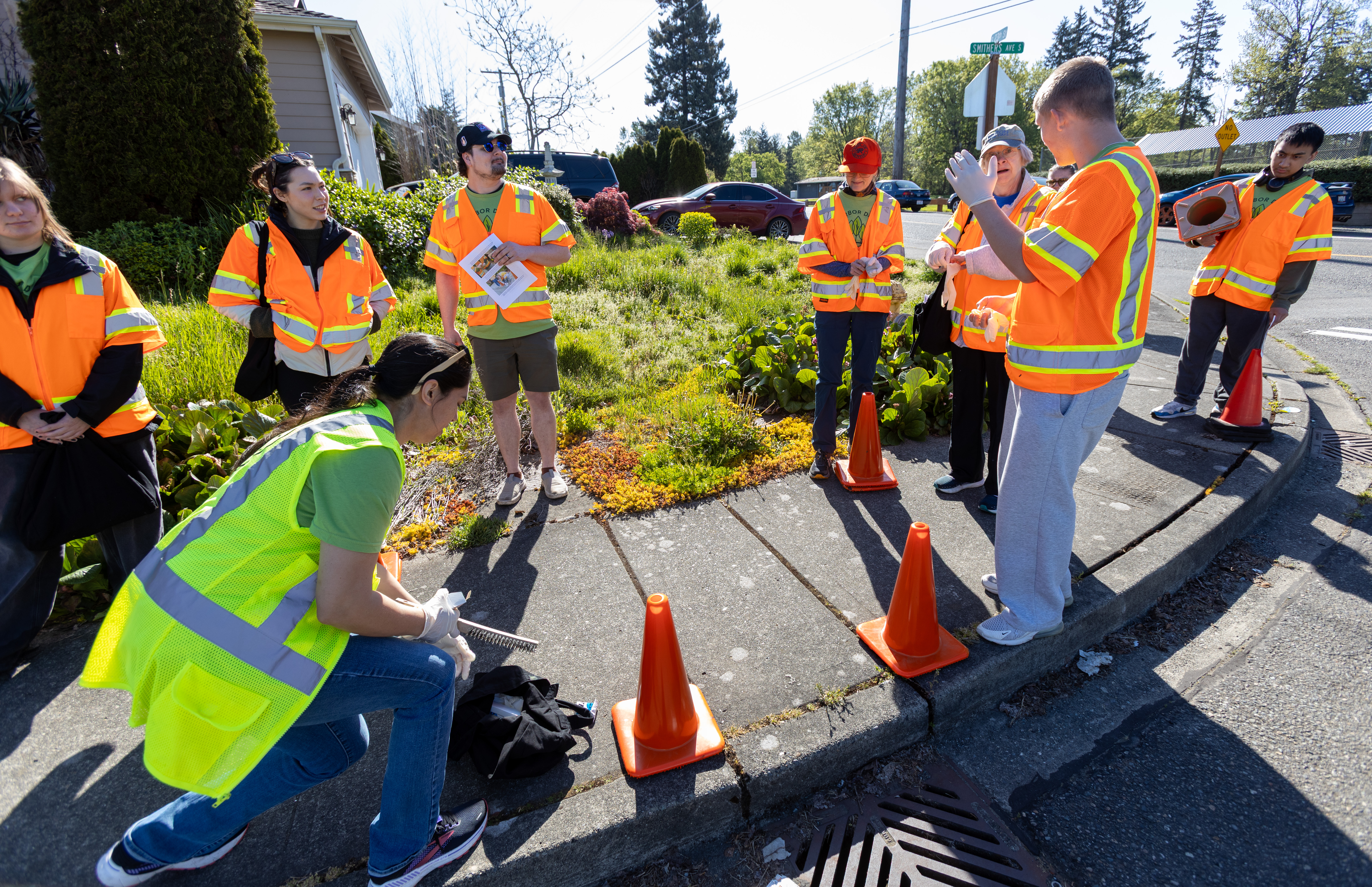 2026-04-25-Storm-drain-marking-volunteers-in-action-on-a-sidewalk.jpg