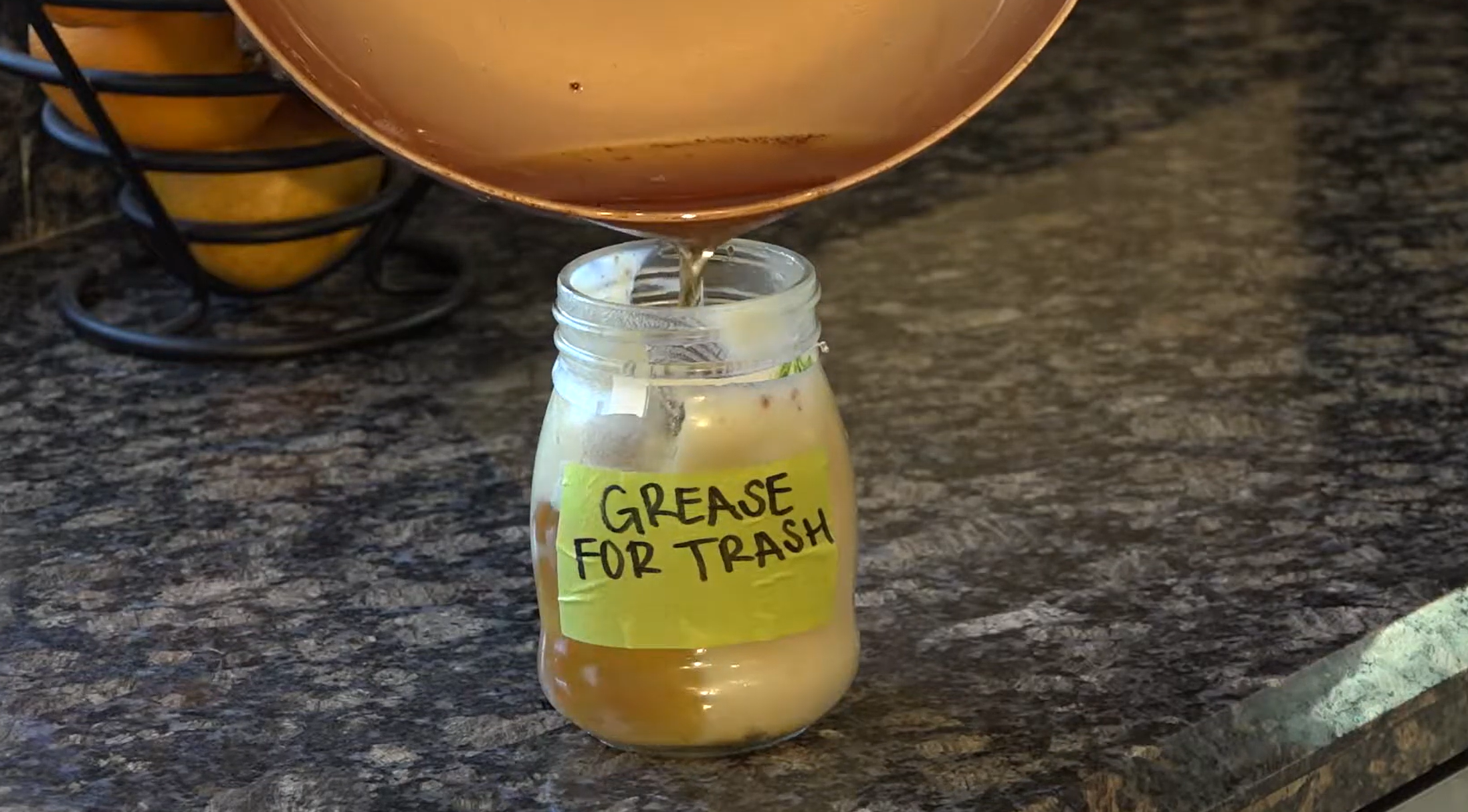 pour-oils-and-grease-into-a-container-for-the-trash.png