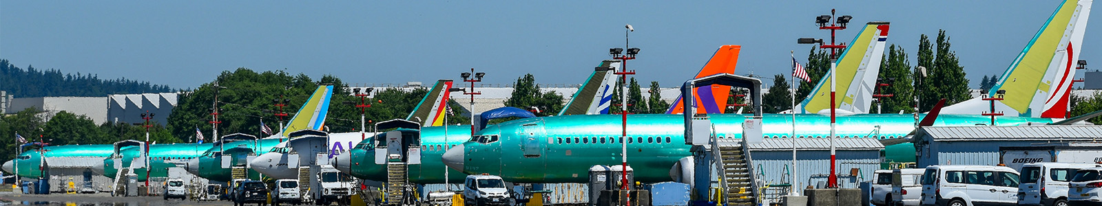 boeing airplanes parked in a row