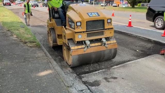 Paver smoothing out concrete
