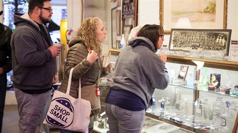 tote bag visible being held by a shopper at a small business store.jpg